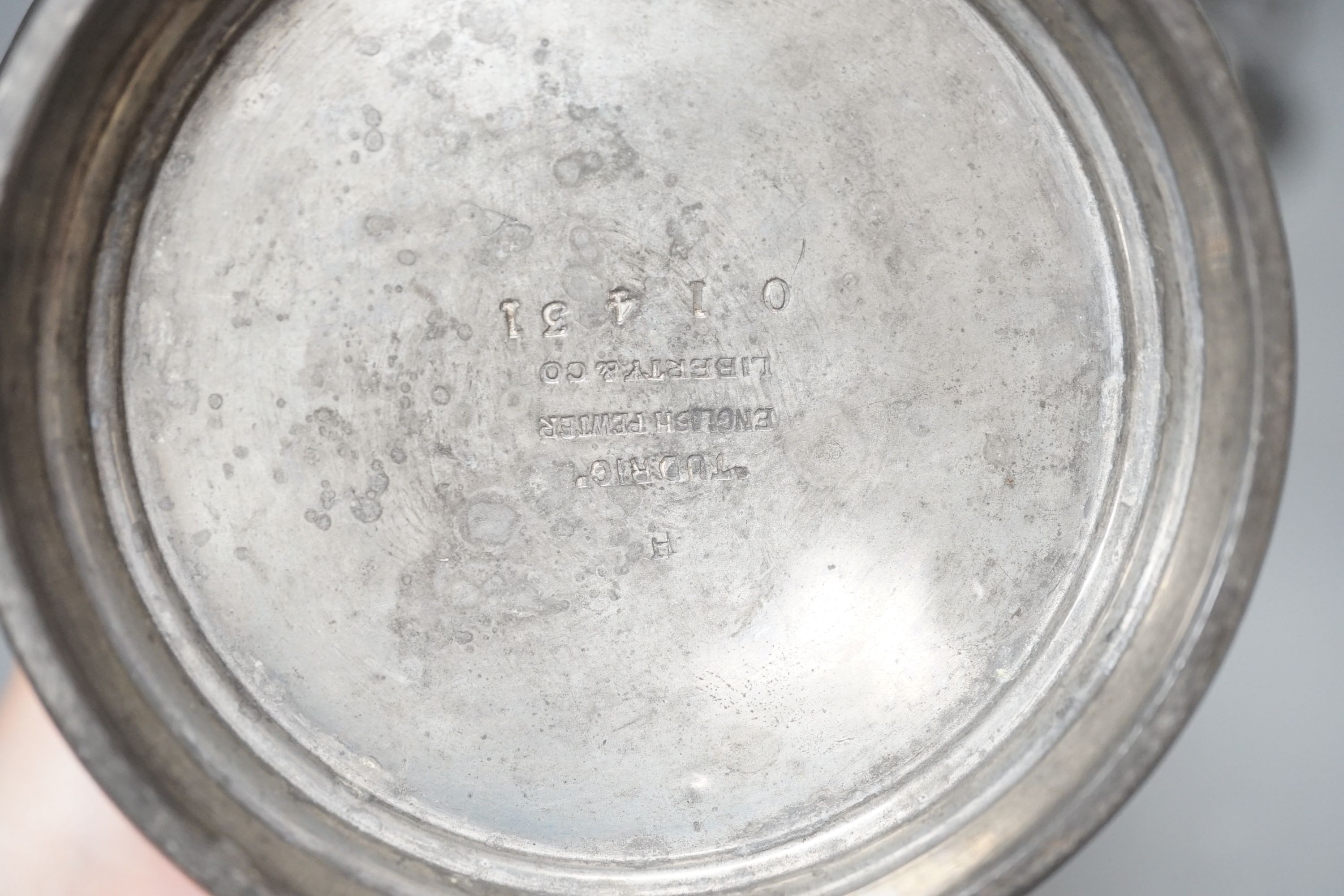 A Liberty & Co. lapis lazuli cabochon mounted Tudric pewter vase, stamped English pewter made by Liberty and Co. 038/4, 18 cm high and two other Tudric pewter vases, tallest 19cms high.